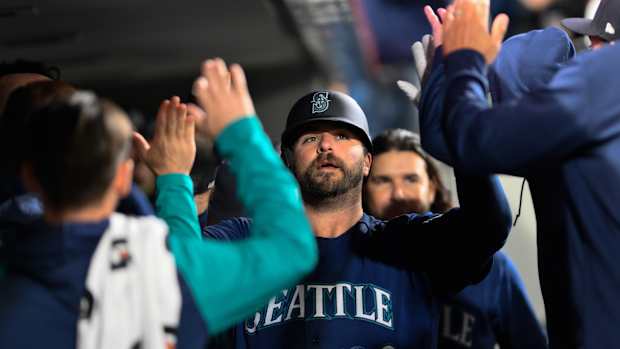 Sep 26, 2023; Seattle, Washington, USA; Seattle Mariners designated hitter Mike Ford (20) celebrates in the dugout after scoring a run against the Houston Astros during the third inning at T-Mobile Park. Mandatory Credit: Steven Bisig-USA TODAY Sports  